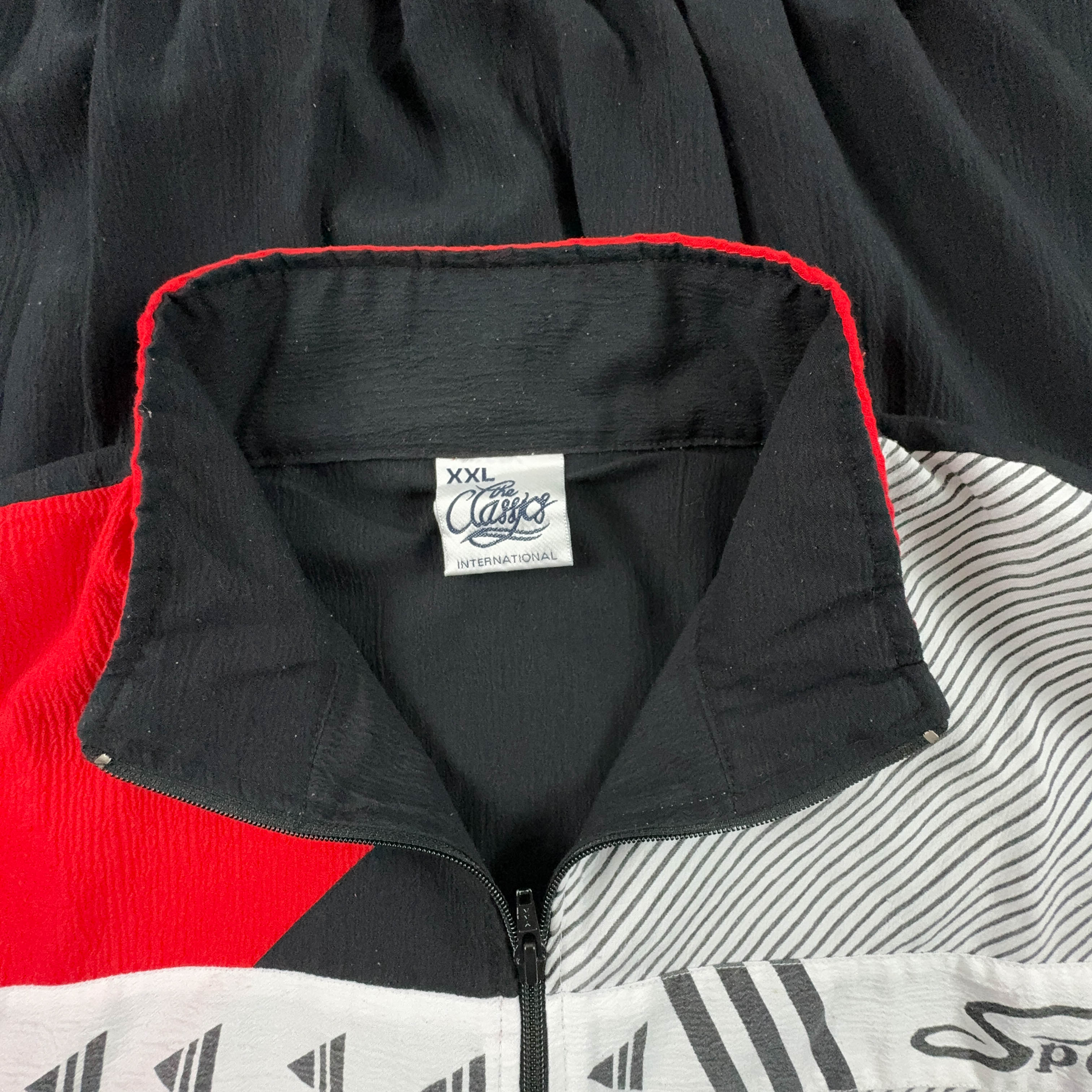 Giacca a vento Vintage nera e rossa geometrica con zip anni 90 - Taglia XL/XXL uomo