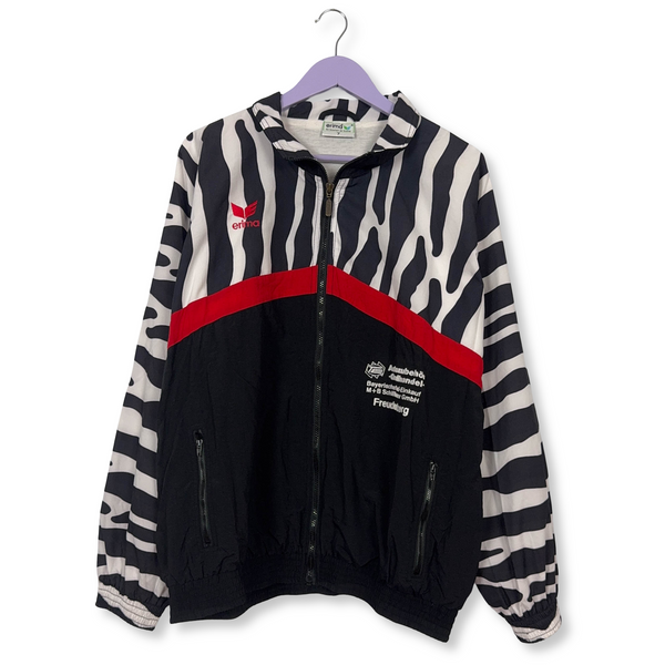 Giacca a vento Erima Vintage nera e bianca con fantasia a strisce e zip anni 90 - Taglia 7 uomo