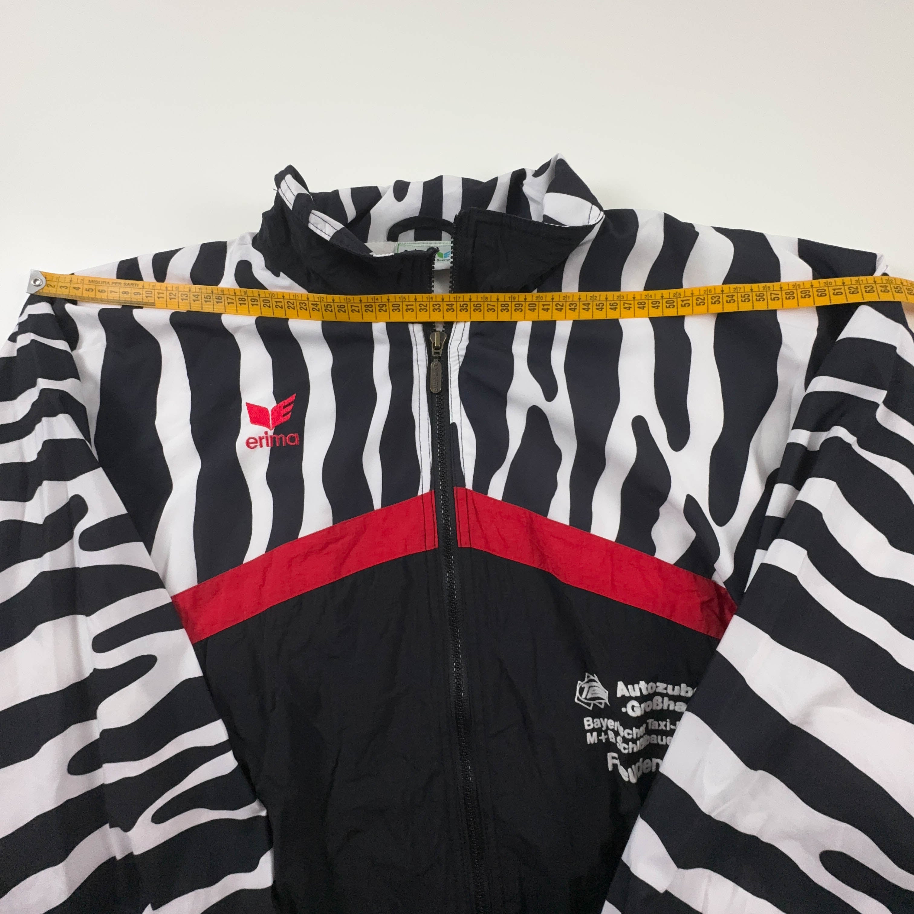 Giacca a vento Erima Vintage nera e bianca con fantasia a strisce e zip anni 90 - Taglia 7 uomo